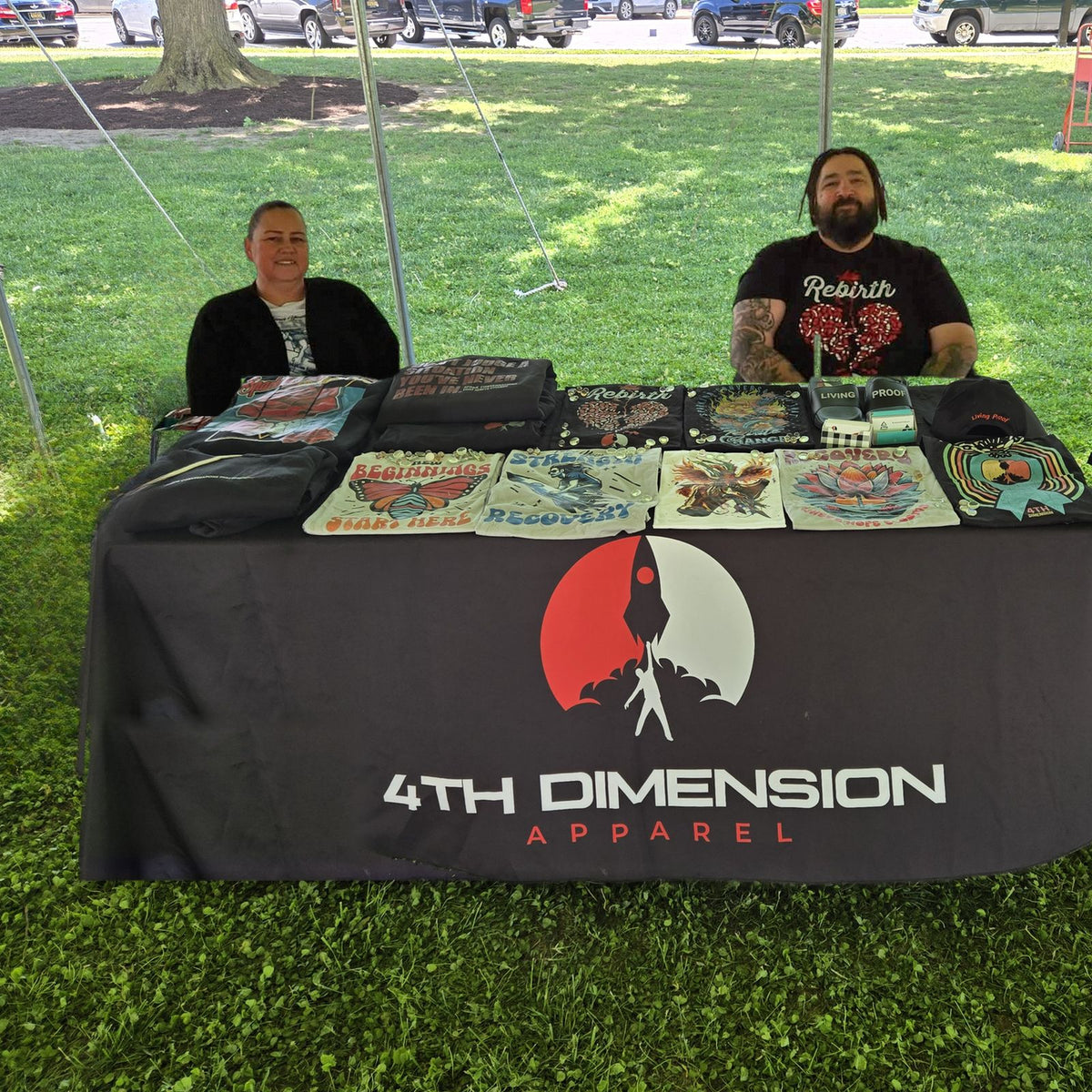 Joseph Hall and his wife at the 4th Dimension Apparel vendor booth