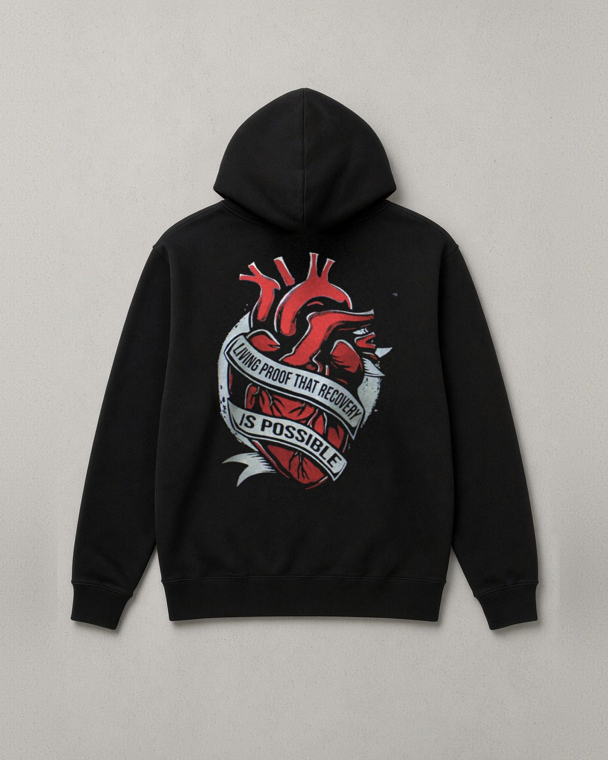 Unchained Heart hoodie back print: red heart wrapped in a banner reading Living Proof That Recovery Is Possible