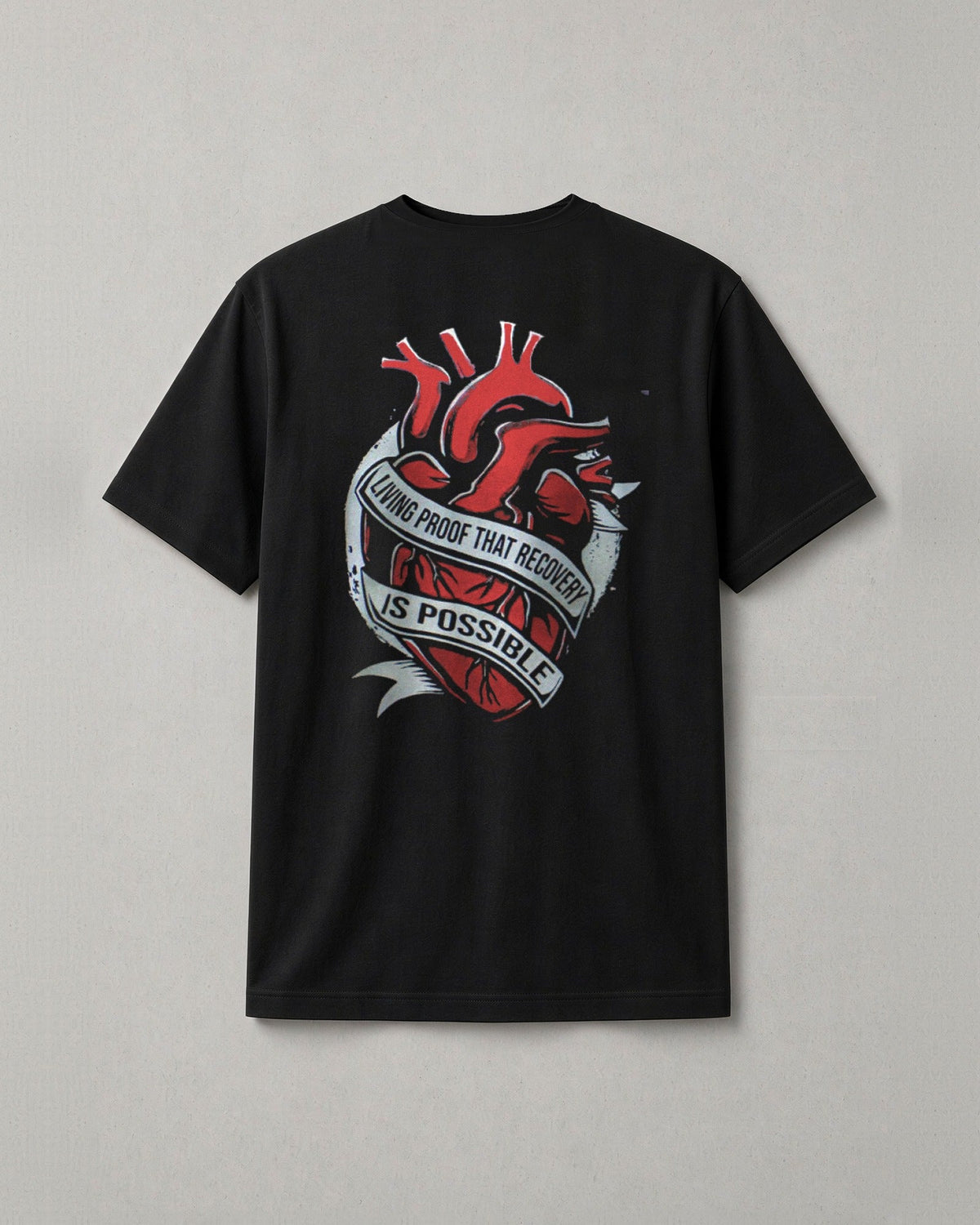 Unchained Heart t-shirt back print: red heart wrapped in a banner reading Living Proof That Recovery Is Possible